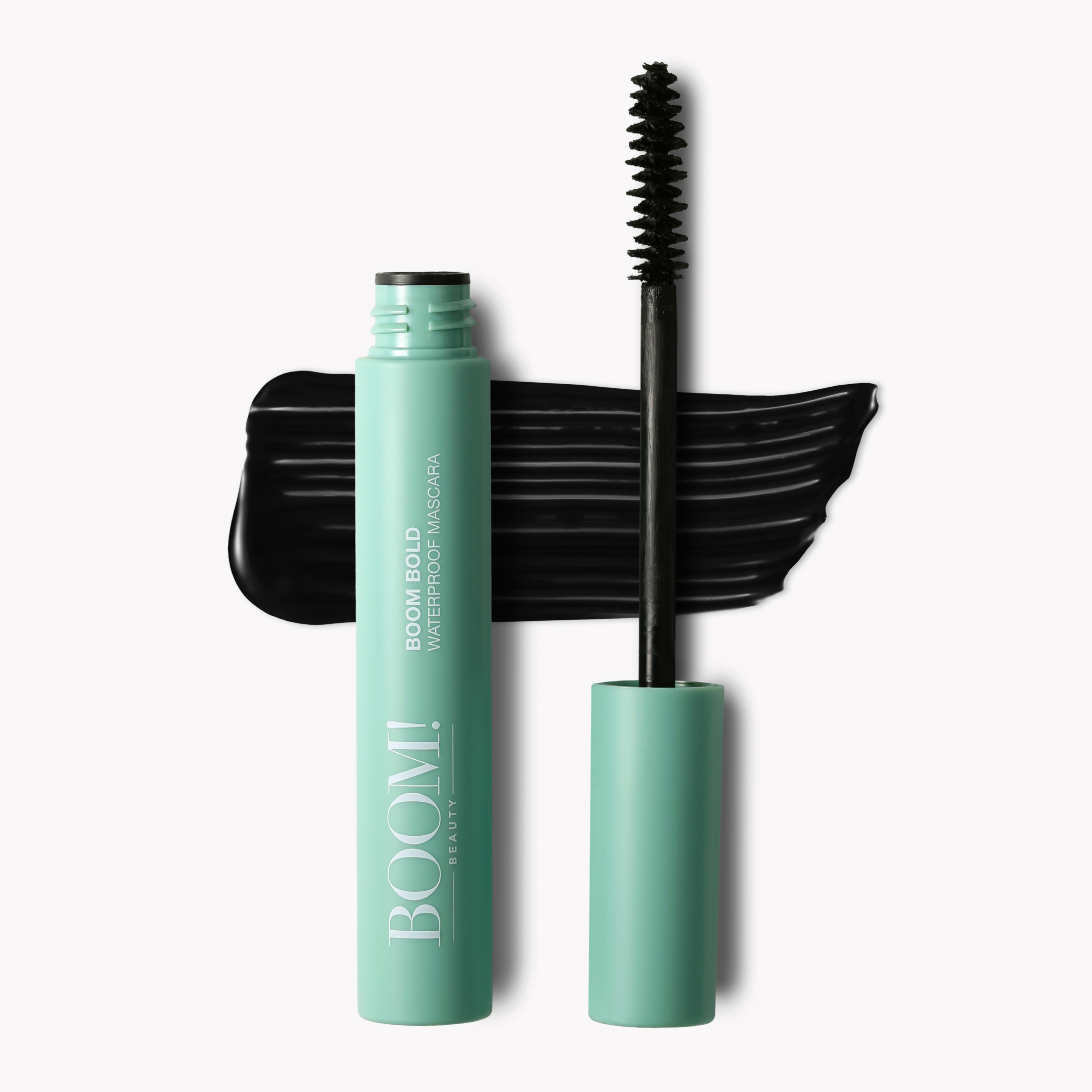 Boom Bold™ waterproof mascara in a mint green tube with a black wand and swatch of black mascara.