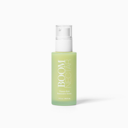 Light green glass bottle of BOOM NECTAR Vitamin Rich Restorative Serum with a white pump and clear cap. 1 fl. oz. / 29.57 mL.